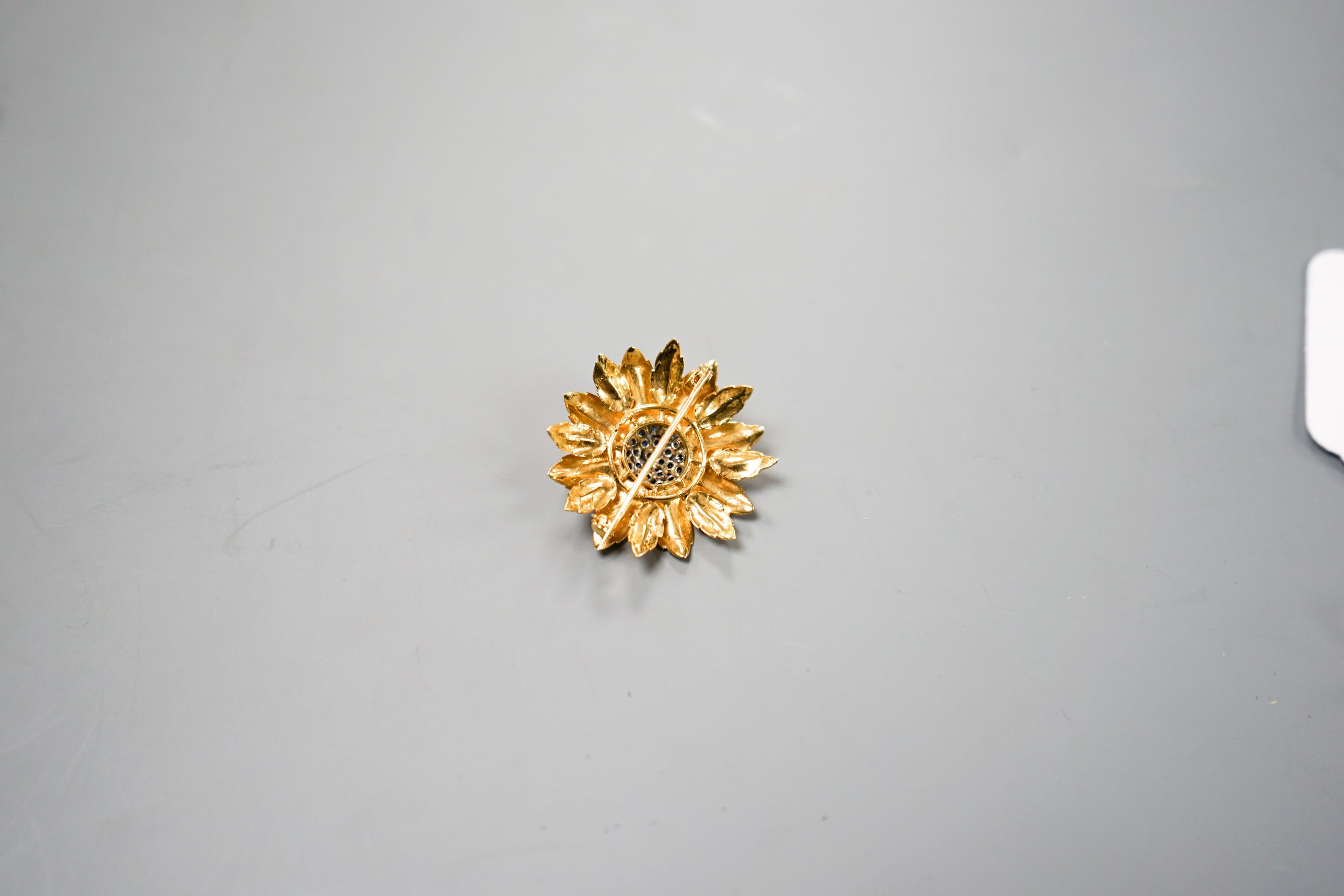 A 1960's 18ct gold, sapphire and diamond cluster set flower head brooch, 35mm.